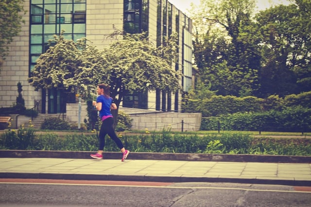 Woman jogging on a city sidewalk