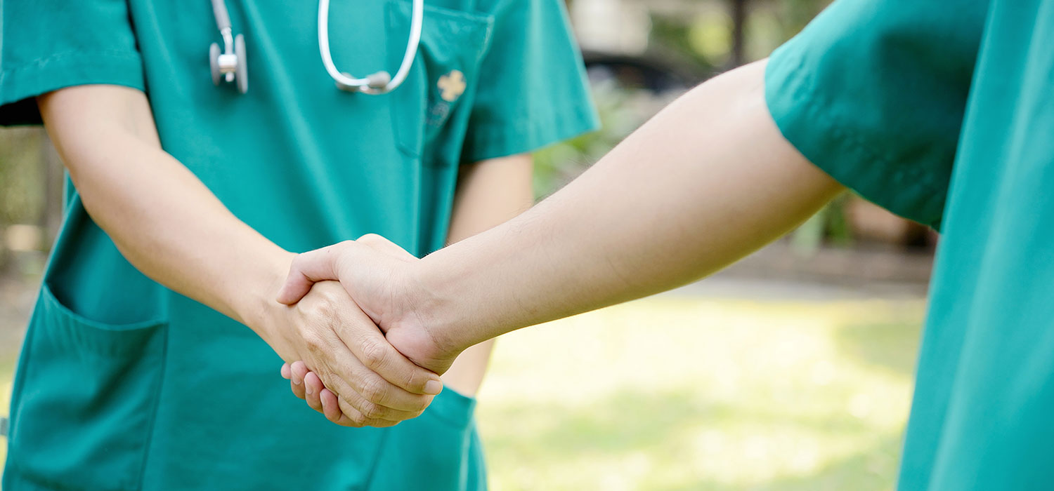 two-healthcare-professionals-shaking-hands-feature