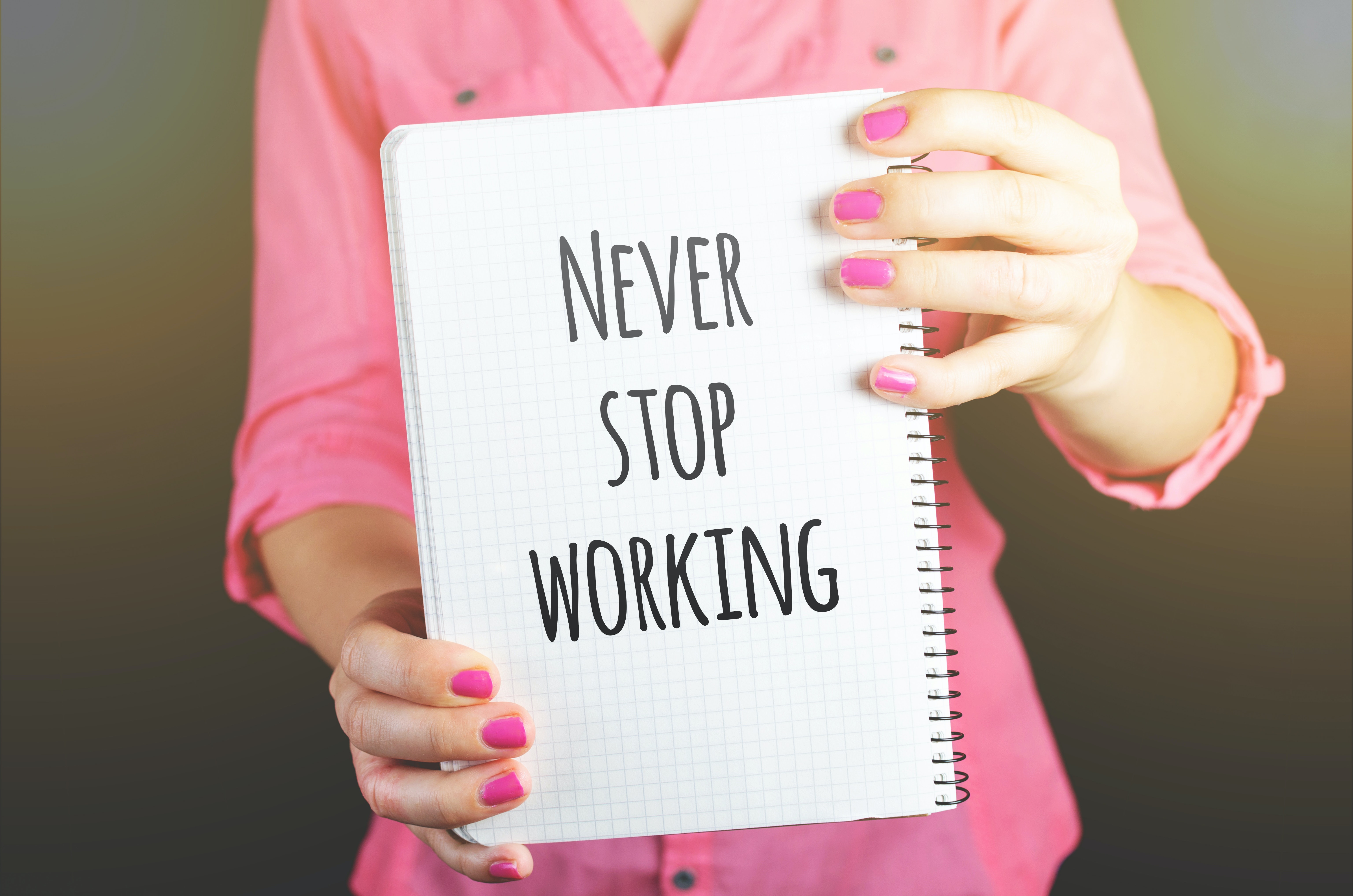 woman-holding-never-stop-working-print-notebook-684363