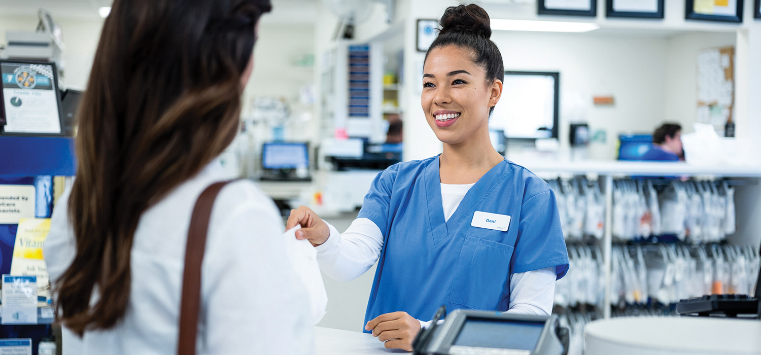 pharmacy-tehcnician-helping-customer-at-retail-counter-header-image